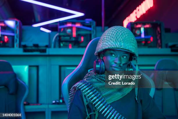 a black fantasy female soldier in a esports gaming cafe - cosplay stockfoto's en -beelden