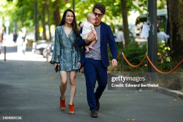 Guest wears a blue / green print pattern satin V-neck / long sleeves short dress, brown red suede open toe-cap wedge sandals, a guest wears black...