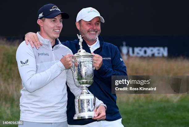 Matthew Fitzpatrick of England celebrates with his caddie Billy Foster after the final round of the 122nd U.S. Open Championship at The Country Club...