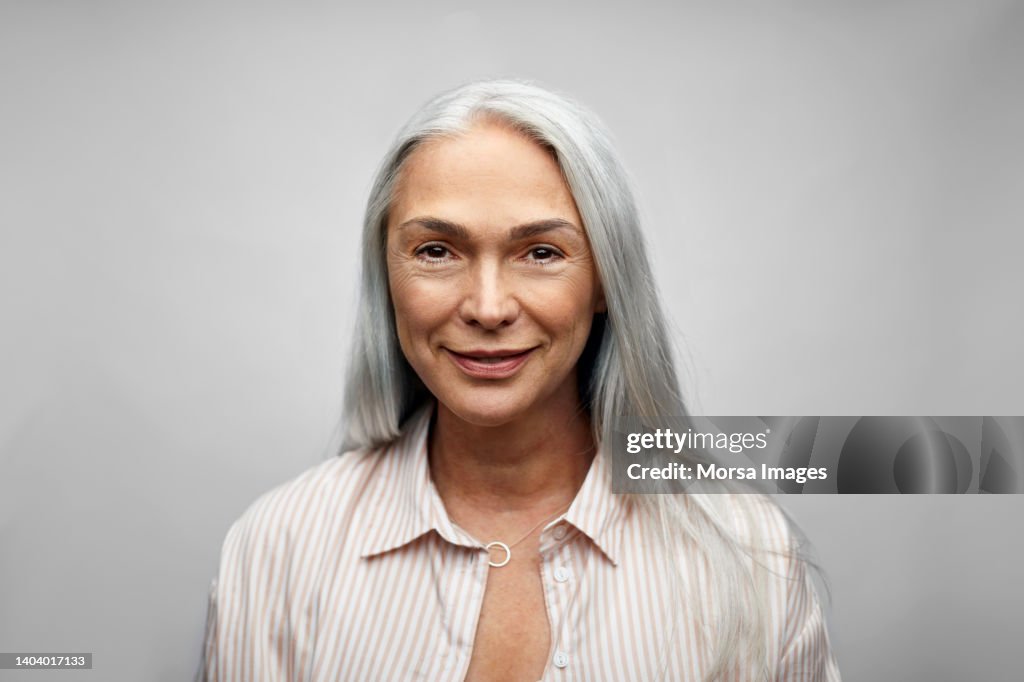 Mature businesswoman smiling on white background