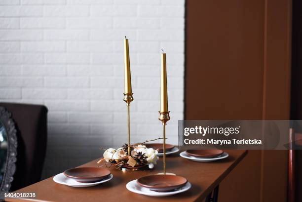 table setting with brown candles. empty table. preparing the table for the holiday. - modern tradition stock pictures, royalty-free photos & images