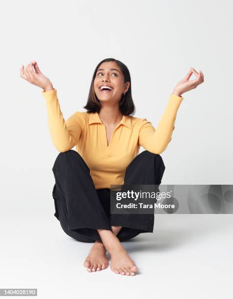 woman meditating - sitting on ground stock pictures, royalty-free photos & images