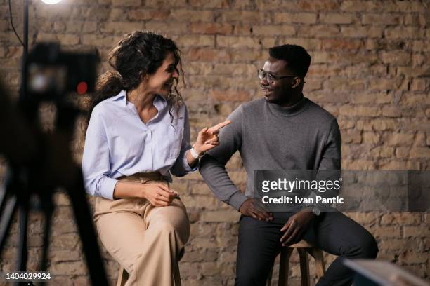 diverse couple of models giving an interview in a studio - television actress stockfoto's en -beelden
