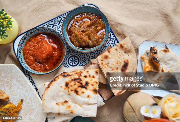 roti served with butter chicken and red curry beef - traditional malay food stock pictures, royalty-free photos & images