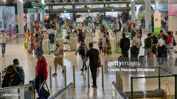 Travelers are seen in TAP's self check-in area in departures hall of Terminal 1 at Humberto Delgado International Airport on June 20, 2022 in Lisbon,...