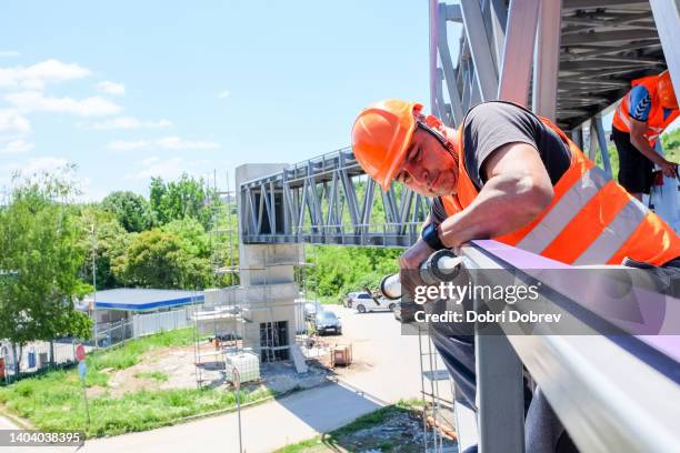 a worker puts glue for mounting exterior aluminum composite panels - glue stock pictures, royalty-free photos & images