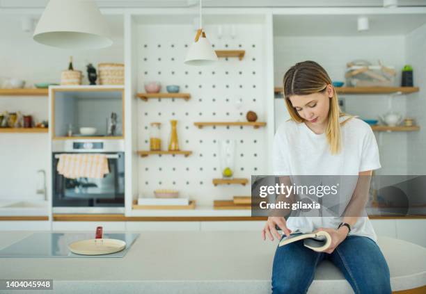 zu hause ein buch lesen. - studentenwohnung stock-fotos und bilder