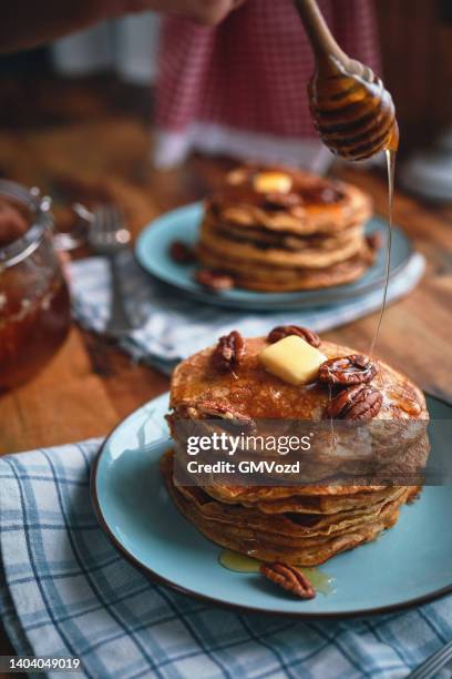 pancakes with butter, pecans and maple syrup - american pancakes stock pictures, royalty-free photos & images