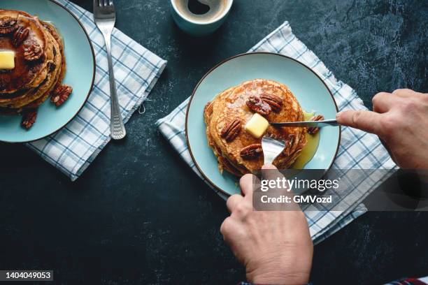 pancakes with butter, pecans and maple syrup - sweet potato pancakes stock pictures, royalty-free photos & images