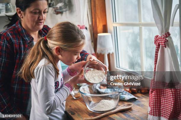 mother and daughter preparing sweet potato pancakes - sweet potato pancakes stock pictures, royalty-free photos & images