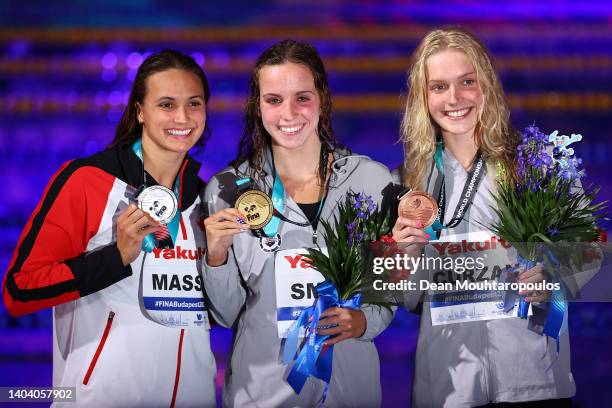 Silver medalist, Kylie Masse of Team Canada, Gold medalist, Regan Smith of Team United States and Bronze medalist, Claire Curzan of Team United...