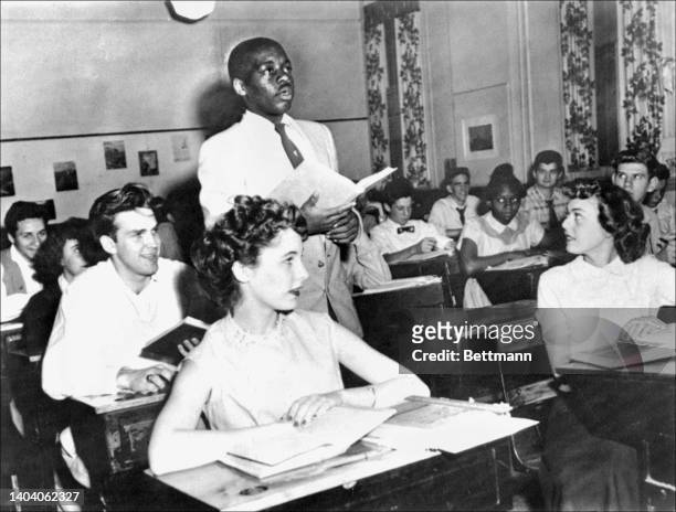 Black student, Nathaniel Steward recites his lesson in a desegregated classroom at the Saint-Dominique school. The Brown v Board of Education...