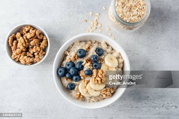 oatmeal porridge banana blueberry - fibre stock pictures, royalty-free photos & images