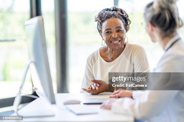 african woman at a medical appointment - black woman nurse bildbanksfoton och bilder