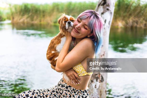 portraits of young woman and her dog by the lake - emotional support animal stock pictures, royalty-free photos & images
