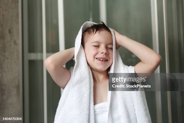 happy boy drying himself with a towel after shower - kids taking a shower stockfoto's en -beelden