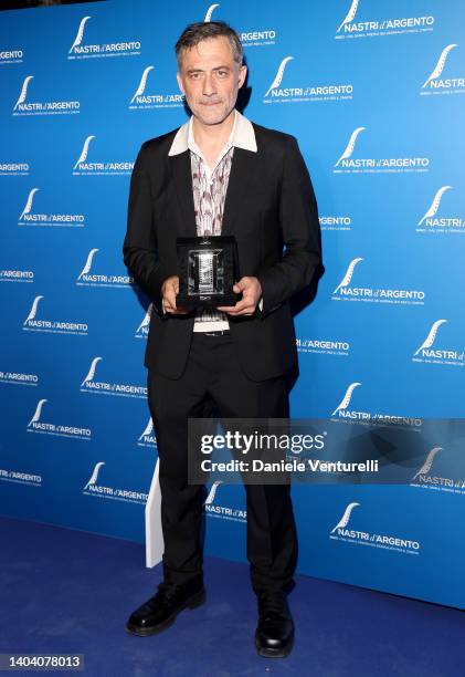 Filippo Timi poses with his Best Comedy Actor Award for "Il Filo Invisibile" at the 76th Nastri D'Argento 2022 on June 20, 2022 in Rome, Italy.