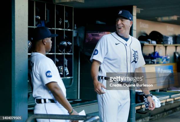 Assistant hitting coach Mike Hessman of the Detroit Tigers laughs with third base coach Ramon Santiago before a game against the Texas Rangers at...