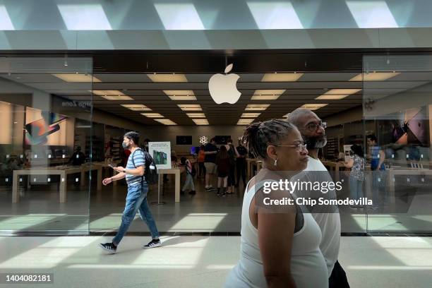 People walk past The Apple Store at the Towson Town Center mall, the first of the company's retail locations in the U.S. Where workers voted over the...