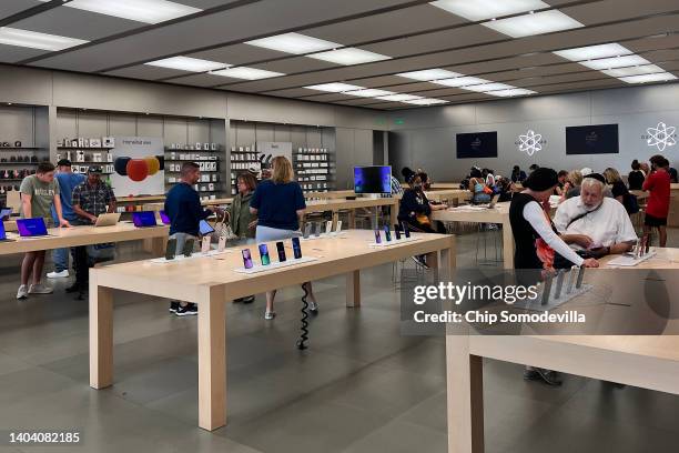 Customers shop at The Apple Store at the Towson Town Center mall, the first of the company's retail locations in the U.S. Where workers voted over...