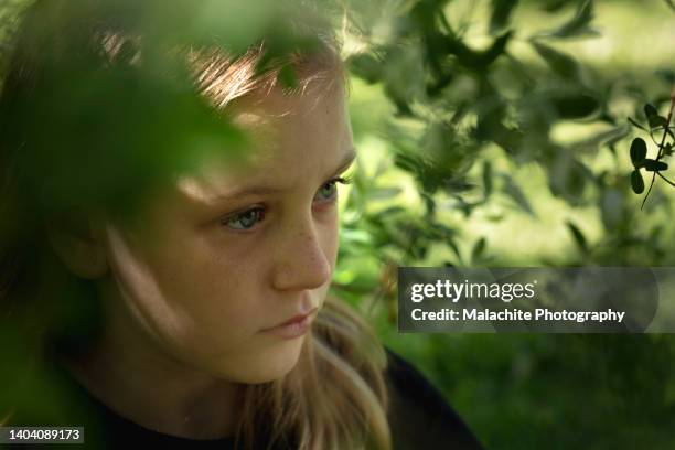 little girl hiding outside dealing with emotional stress - 人間の眼 ストックフォトと画像