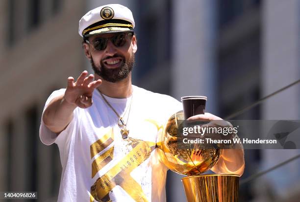 Klay Thompson of the Golden State Warriors celebrates with the NBA Championship Trophy during the Golden State Warriors Victory Parade on June 20,...