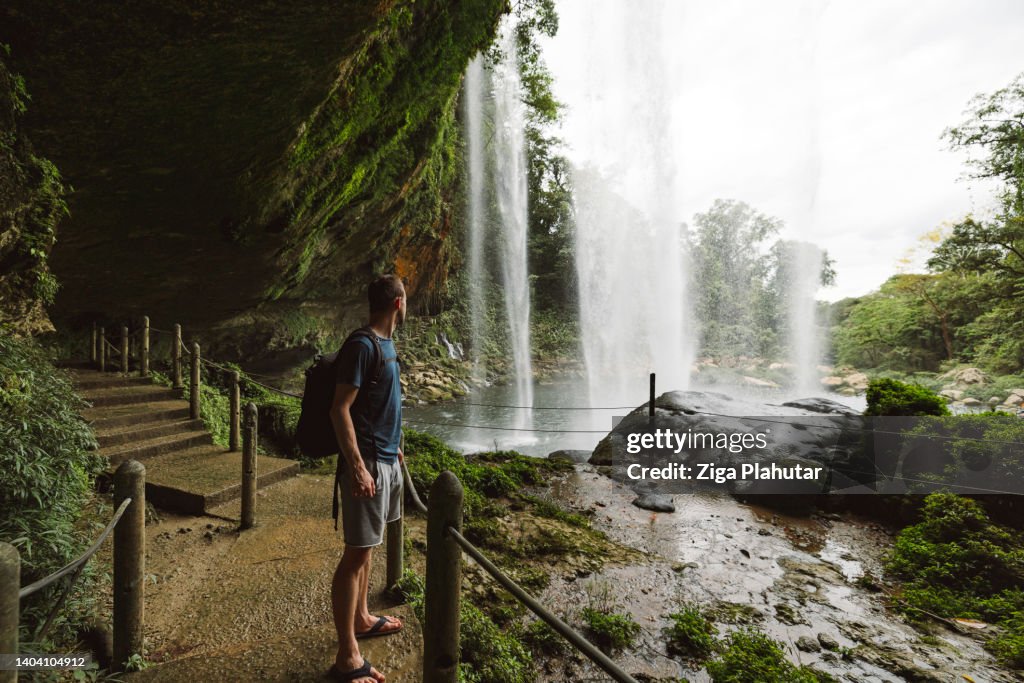 Caucasian tourist at Misol-Ha waterfall
