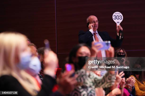 Bidder raises their auction paddle for the winning bid at a charity auction of the 2021 Nobel Peace Prize of Dmitry Muratov, editor-in-chief of the...