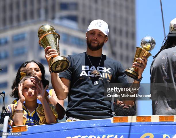 Stephen Curry of the Golden State Warriors, his wife Ayesha, and daughter Riley celebrate with his NBA Finals Most Valuable Player Award during the...