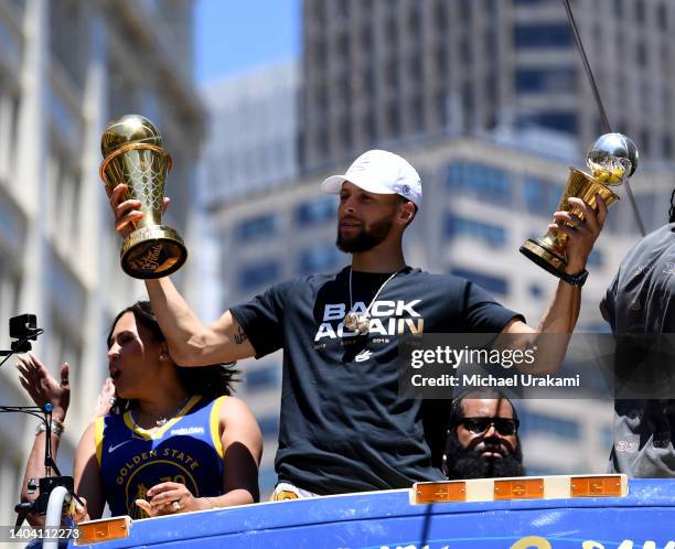 Stephen Curry of the Golden State Warriors and wife Ayesha celebrate with his NBA Finals Most Valuable Player Award during the Victory Parade on June...