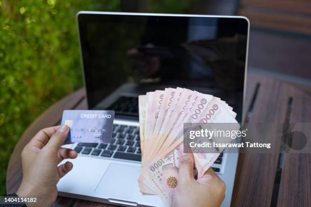 successful beautiful asianbusiness young woman holding credit card in hand , business concept ,good mood, demonstrating they could borrow money easily and can now achieve their goals concept. - all asian currencies stock pictures, royalty-free photos & images