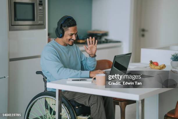 asia indian with disability  sitting on wheelchair in dinning room video call with laptop - one mid adult man only bildbanksfoton och bilder