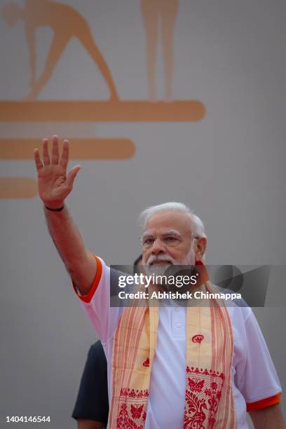 Indian Prime Minister Narendra Modi greets a gathering of people in front of the Mysore Palace during the International Day of Yoga celebrations, on...