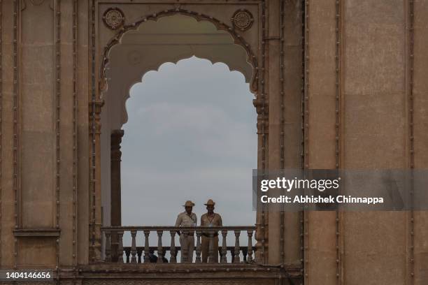 Police personnel maintain vigil from the ramparts of the Mysore Palace during the International Day of Yoga celebrations, on June 21, 2022 in Mysuru,...