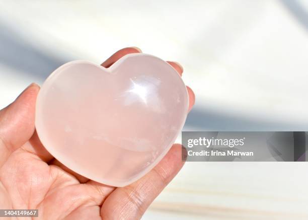 heart shaped girasol quartz crystal horizontal - the shamen stock-fotos und bilder