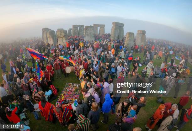 People gather for sunrise at Stonehenge, on June 21, 2022 in Wiltshire, England. The summer solstice occurs on June 21st, it is the longest day and...