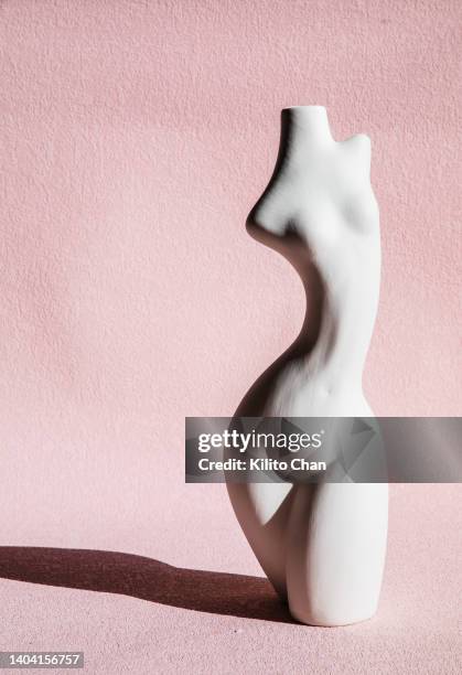 the female body pottery against pink background - fertility statue stock pictures, royalty-free photos & images