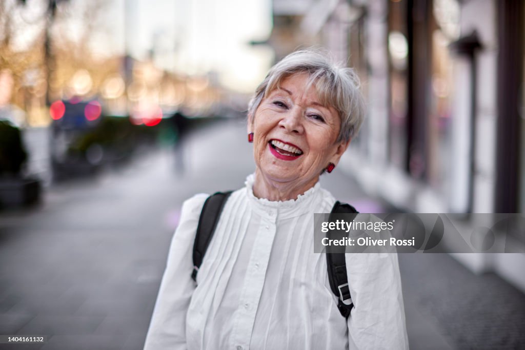 Portrait of happy senior woman in the city