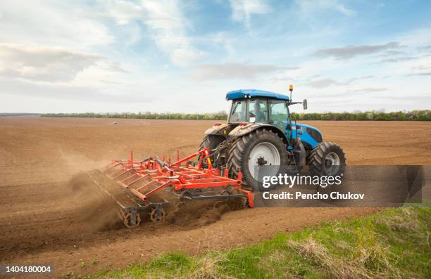 small scale farming with tractor and plow in field - plough stock pictures, royalty-free photos & images