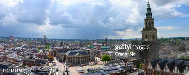 groningen city skyline panoramic view with a dramatic sky above - groningen stad stockfoto's en -beelden