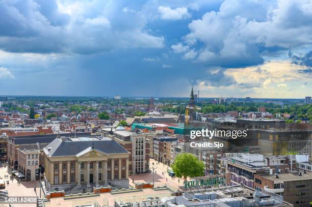 groningen grote markt city skyline panoramic view with a dramatic sky above - groningen stad stockfoto's en -beelden