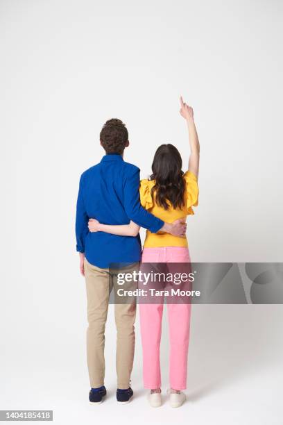 rear view of two people - vertical photos et images de collection
