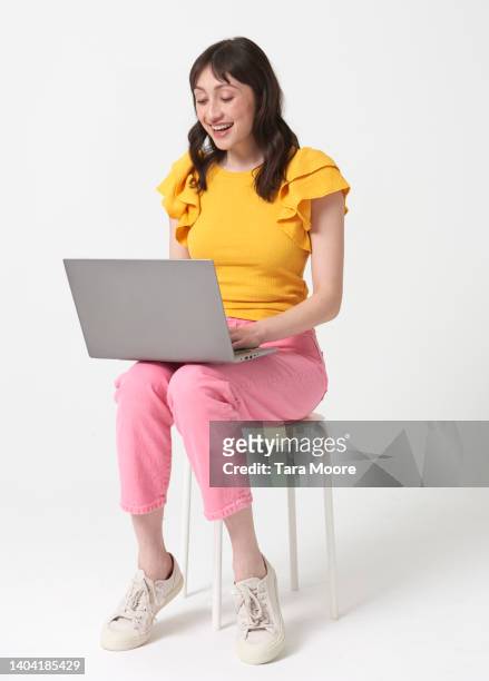 woman with laptop - laptop white background stock-fotos und bilder