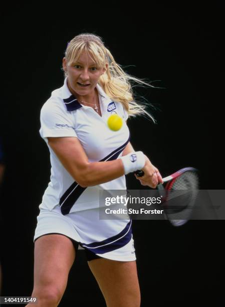 Mirjana Lucic-Baroni from Croatia keeps her eye on the tennis ball playing a double handed backhand return against compatriot Silvija Talaja during...