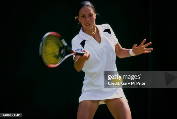 Anastasia Myskina from Russia playing a forehand return against Ai Sugiyama of Japan during their Women's Singles Second Round match at the Wimbledon...