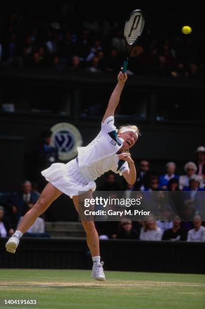 Jana Novotna from the Czech Republic reaches to serve to Venus Williams of the United States during their Women's Singles Quarter Final match at the...