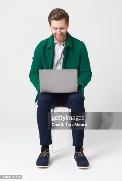man looking at laptop - laptop studio shot stock pictures, royalty-free photos & images