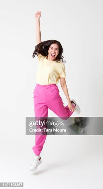 woman jumping for joy - celebration people on white stock-fotos und bilder