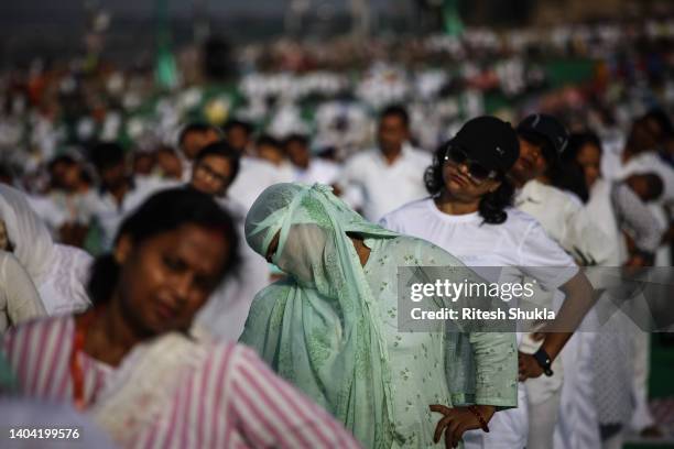 People take part in a mass yoga session on the banks of the holy sangam, the confluence of the Ganges, Yamuna and mythological Saraswati rivers, on...