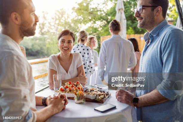 colleagues at the banquet, during the team building event - chat canapé stock pictures, royalty-free photos & images